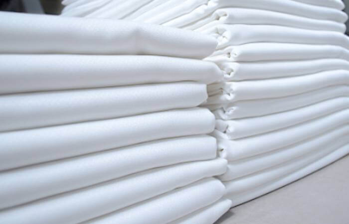 How do hotels keep sheets wrinkle-free? They use professional laundries and pressing machines.